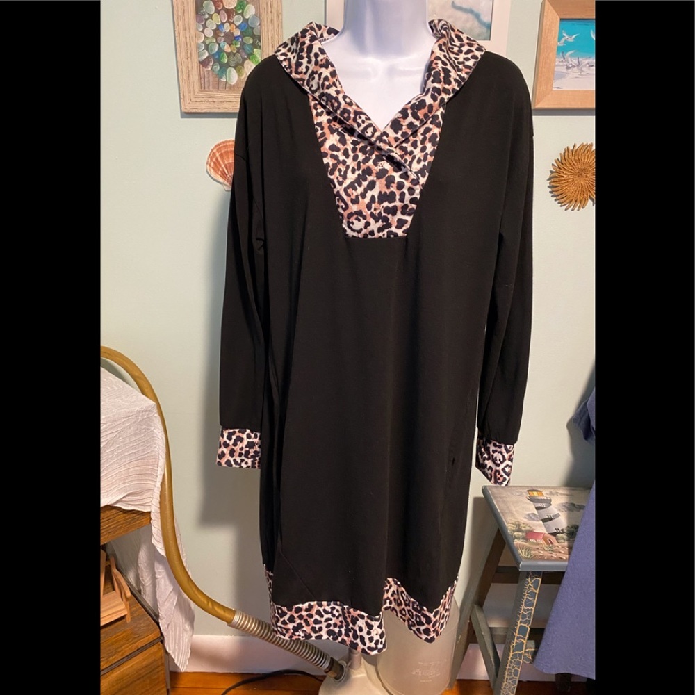 Black dress with animal print on neck, sleeves and trim.​